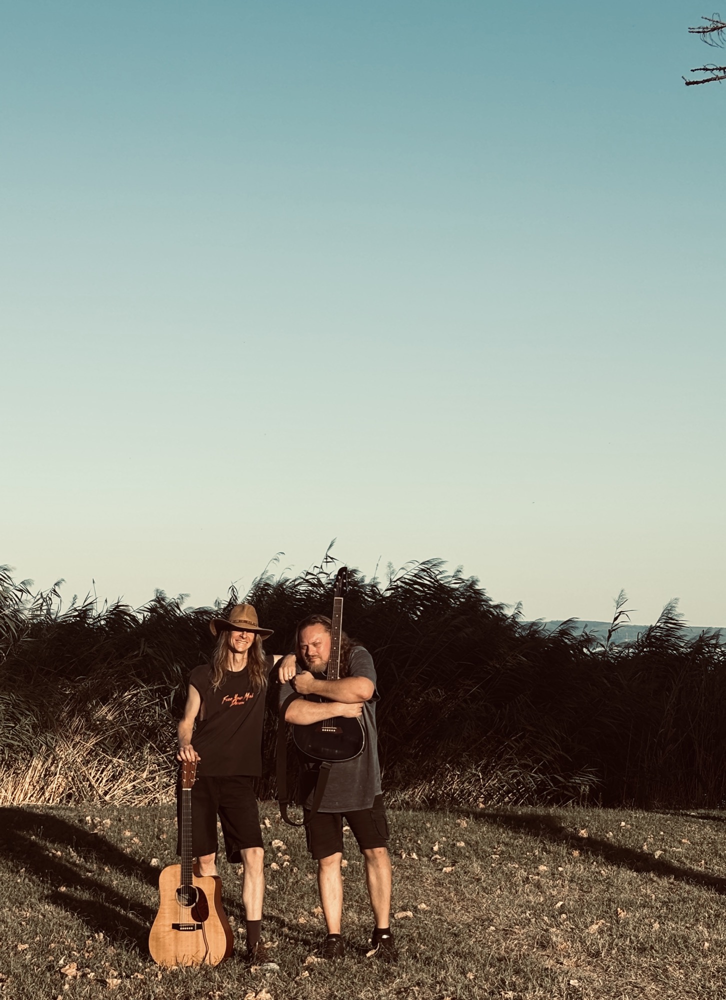 DeLoreans members by the lake at sunset