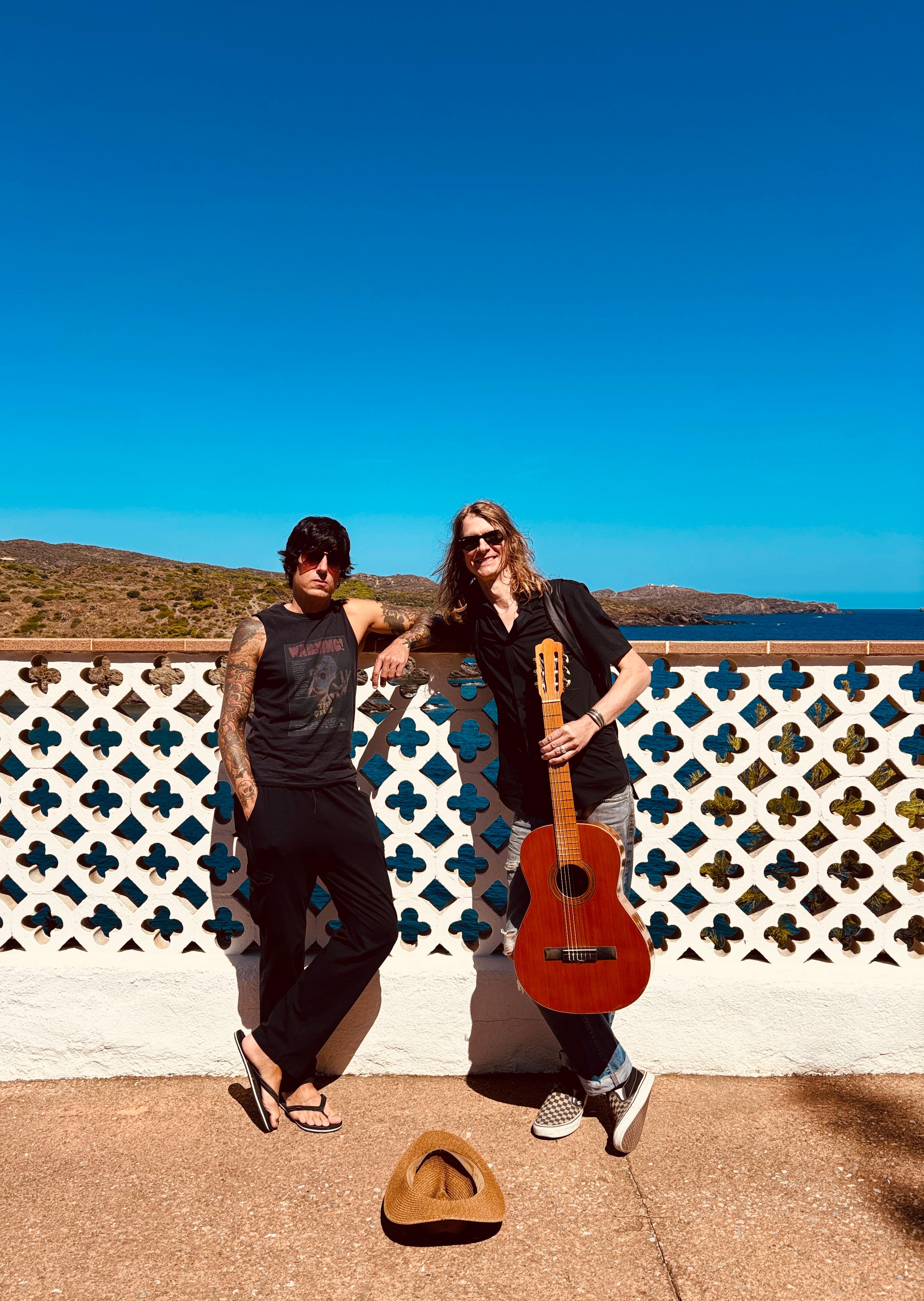 Adam Arling with guitar by the sea